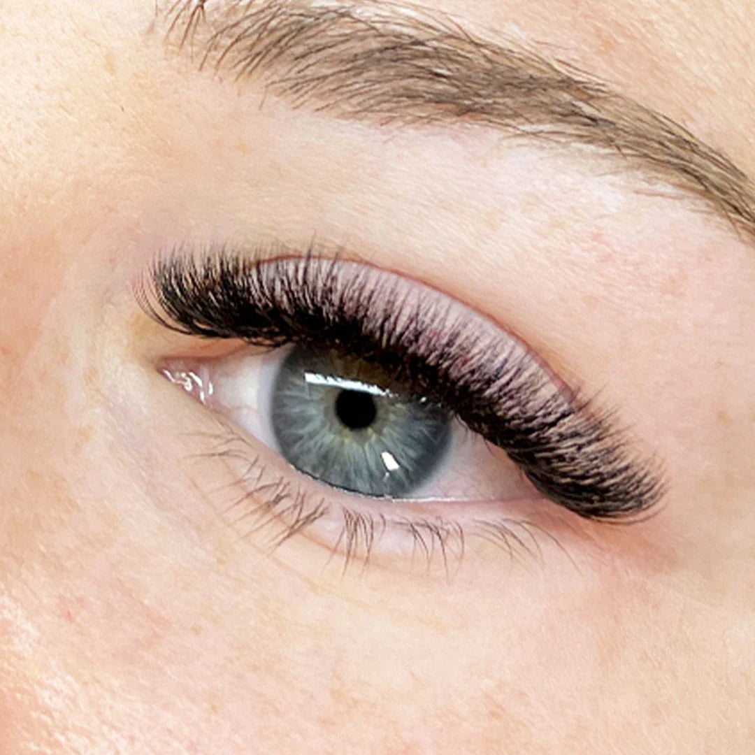 Close-up of a person's eye with detailed eyelash extensions using Close-up of an eye with long, dark eyelashes and a well-groomed eyebrow. using Wet & Wispy professional 5D bundles of false eyelashes lash box LA innovation in lashes, for perfect russian volume bundle no counting and for wet spikes easily made. 
