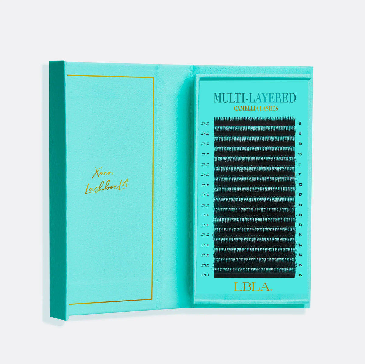 Teal box containing false eyelashes with 'LBLA' branding on a white background Multi layered camellia lash tray with long and short lengths blended curls all in one easy to use lash strip for uncomplicated lash mapping allowing you the lash artist to create effortless texture in every set wispy style. 