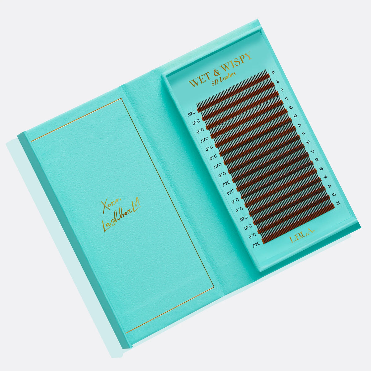 Open turquoise box containing false eyelashes with 'Wet & Wise' branding on a light gray background.